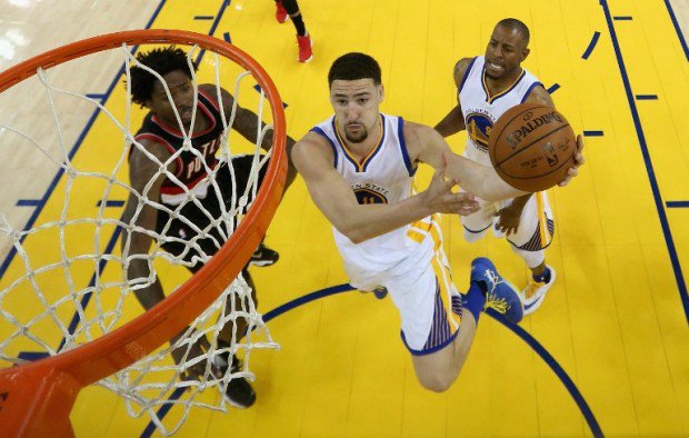 OAKLAND CA- MAY 03 Klay Thompson #11 of the Golden State Warriors goes up for a shot against Ed Davis #17 of the Portland Trail Blazers during Game Two of the Western Conference Semifinals during the 2016 NBA Playoffs