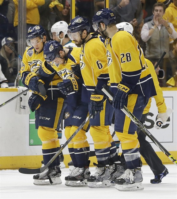 Nashville Predators center Colton Sissons second from left is helped off the ice by Miikka Salomaki, of Finland left Shea Weber and Paul Gaustad after Sissons was injured during the third period in Game 3 of an NHL hockey Stanley Cup Wes