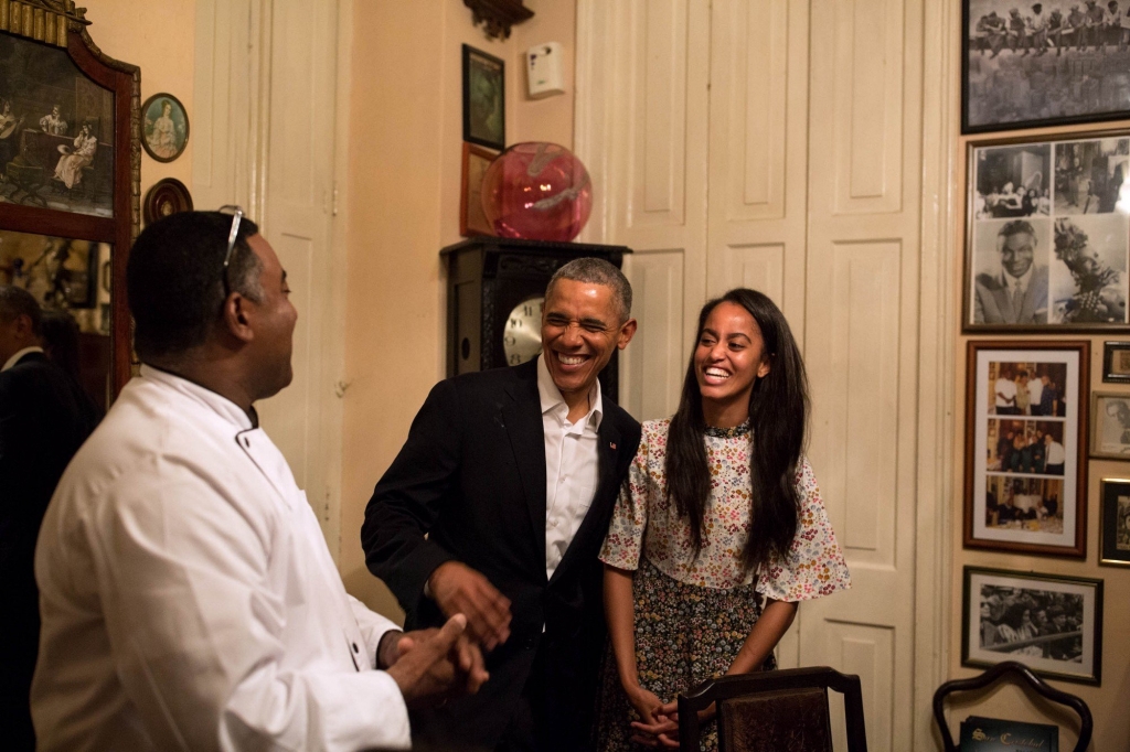 President Barack Obama and daughter Malia share a laugh as Malia interprets in Spanish for a restauranteur in Havana Cuba Sunday