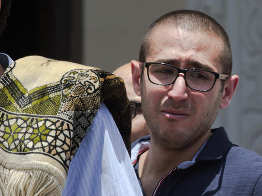 A relative of Salah Abu Laban Sahar Qouidar Ghassan Abu Laban and Reem al-Sebaei all victims of Egypt Air flight 804 grieves following prayers for the dead at al Thawrah Mosque in Cairo Egypt Friday