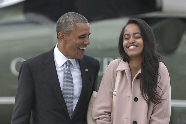 US President Barack Obama and daughter Malia make their way to board Air Force One before departing from Chicago OHare International Airport in Chicago