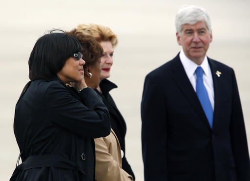 Flint Mich. Mayor Karen Weaver Rep. Rep. Brenda Lawrence D-Mich. and Sen. Debbie Stabenow D-Mich. and Michigan Gov. Rick Snyder await the arrival of President Barack Obama on Air Force One at Bishop International Airport in Flint Mich. Wednesday