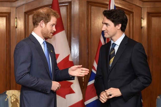 Prime Minister Justin Trudeau speaks with Prince Harry during the Prince's visit to Toronto to promote the 2017 Invictus Games which the city will be hosting on Monday