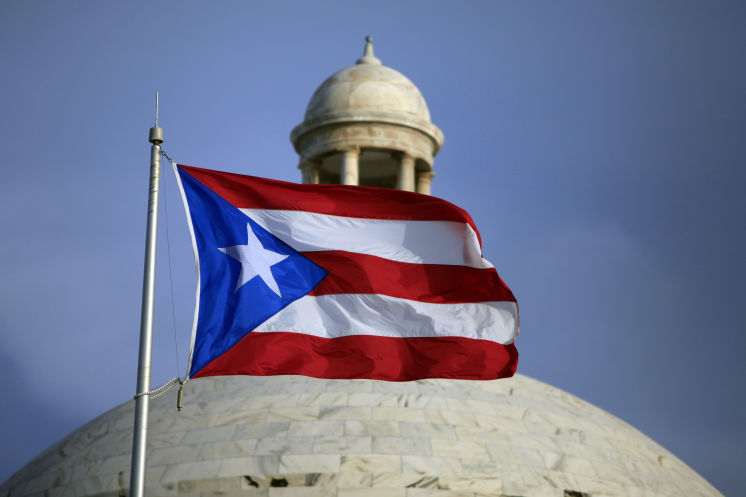 The Puerto Rican flag flies in front of Puerto Rico's Capitol in San Juan. Puerto Rico Gov. Alejandro Javier Garcia Padilla said on Sunday that negotiators for the U.S. territory's government have failed to reach a last-minute deal to avoid a third defaul