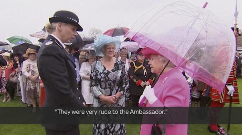 In image made from pool video Queen Elizabeth II speaks with Metropolitan Police Commander Lucy D'Orsi in the garden of Buckingham Palace in London