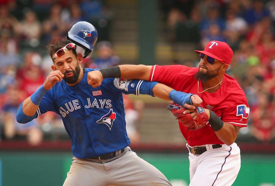 Toronto Blue Jays Jose Bautista gets hit by Texas Rangers second baseman Rougned Odor after Bautista slid into second in the eighth inning of a baseball game at Globe Life Park in Arlington Texas Sunday