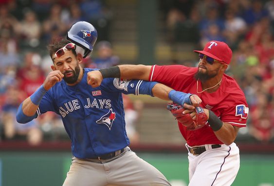 Jose Bautista gets hit by Texas Rangers second baseman Rougned Odor after Bautista slid into second in the eighth inning of a baseball game at Globe Life Park in Arlington Texas Sunday