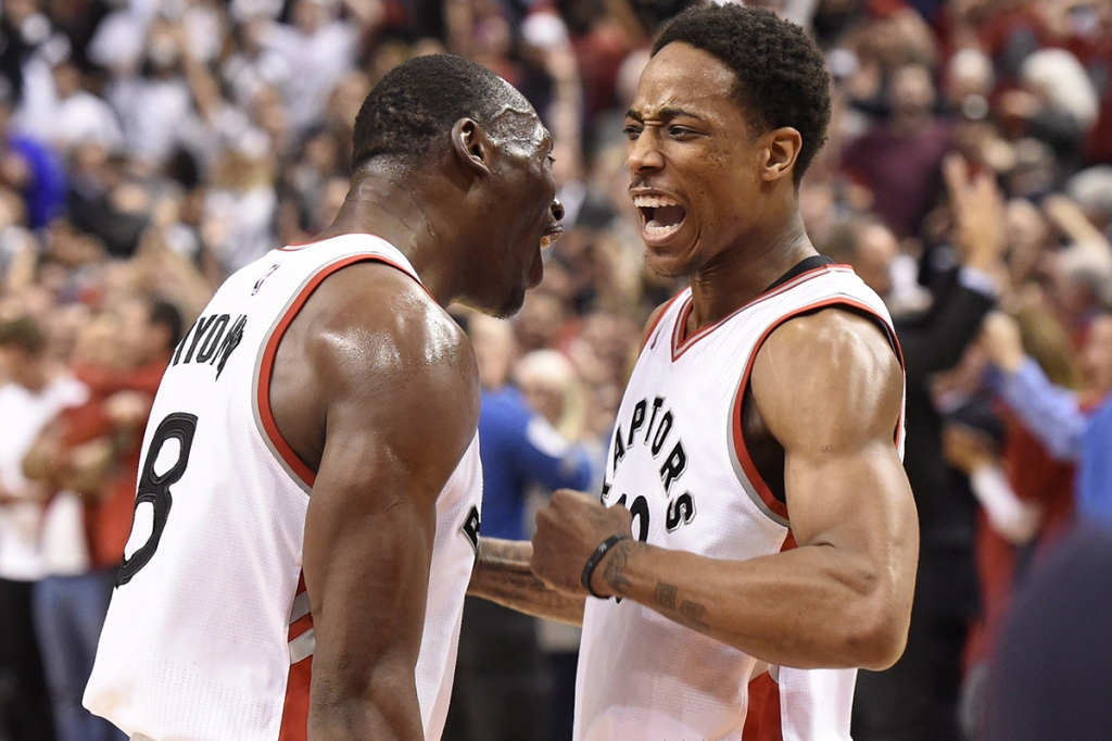 Toronto Raptors guard De Mar DeRozan celebrates his team's victory over the Indiana Pacers with teammate Bismack Biyombo