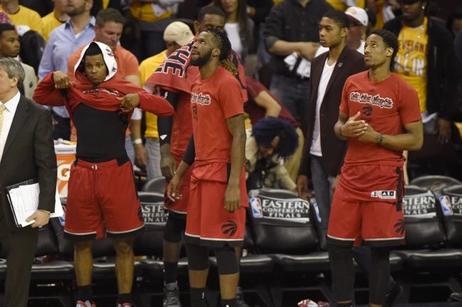 Toronto Raptors players Toronto Raptors guard Kyle Lowry left to right De Marre Carroll and Toronto Raptors guard De Mar DeRozan look on from the sidelines late in the second half Eastern Conference final NBA playoff basketball action against the Clevelan