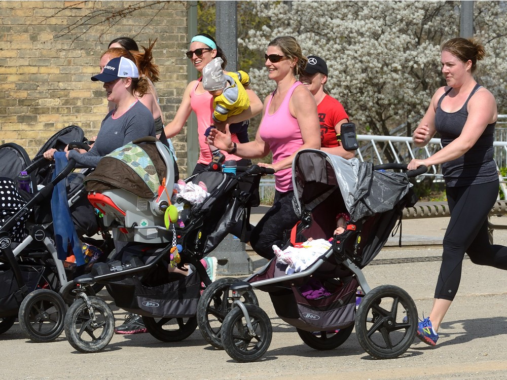 Jessica Butt Kristen Nagel Beki Dries trainer Bernice Robinson and Sarah Denomy l-r jog with their babies in strollers in Ivey Park in London Ontario on Thursday