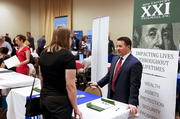 Recruiters speak to attendees at a job fair in Pittsburgh this week