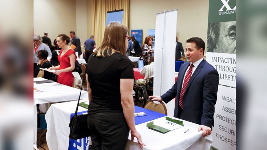 Recruiters talk to those looking at employment opportunities at a job fair in Pittsburgh