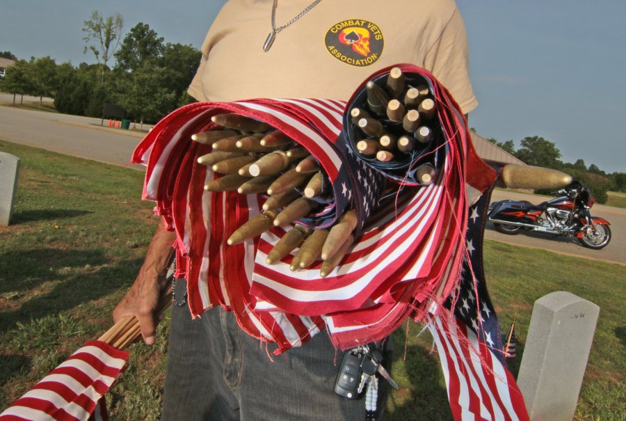 KEN RUINARD  Independent Mail Veterans and volunteers recently placed more than 1,000 U.S. Flags on graves at M.J. Dolly Cooper Veterans Cemetery in Anderson