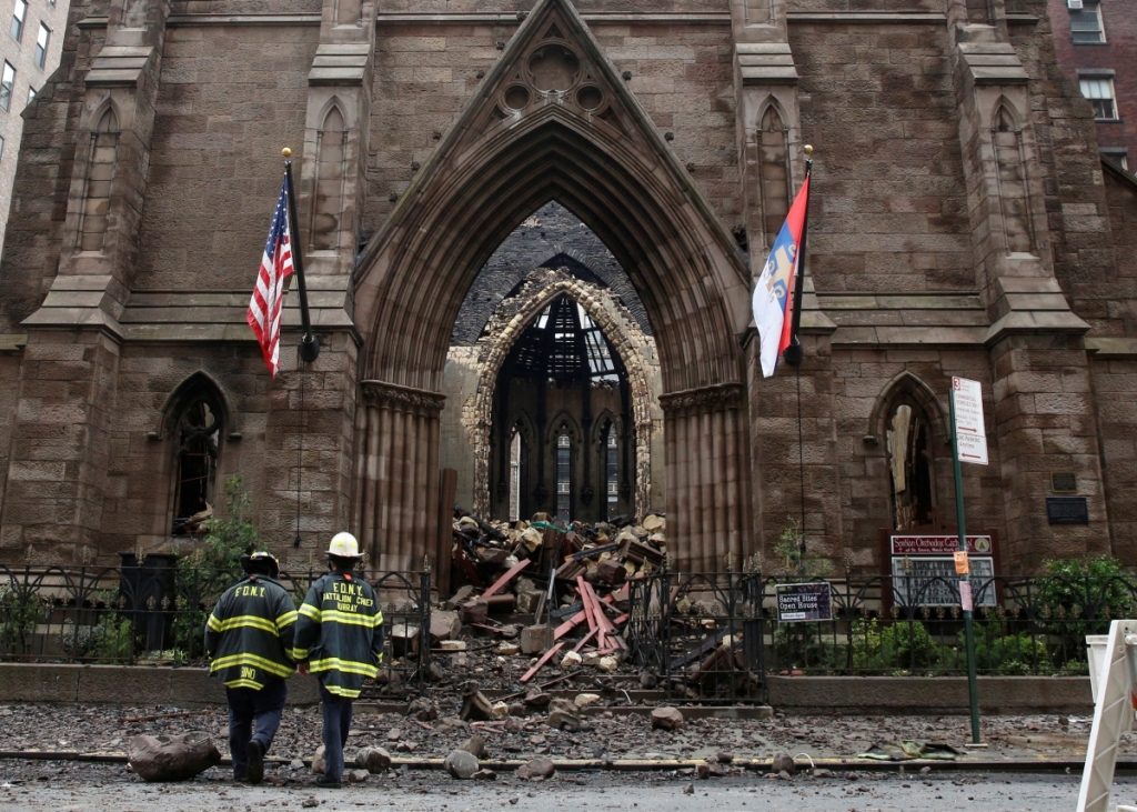 ReutersNew York City firefighters walk at the historic Serbian Orthodox Cathedral of Saint Sava that was gutted by fire at Orthodox Easter