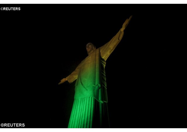 Rio's statue of Christ the Redeemer is lit up in the yellow and green colours of Brazil's flag 100 days before the 2016 Olympics- REUTERS