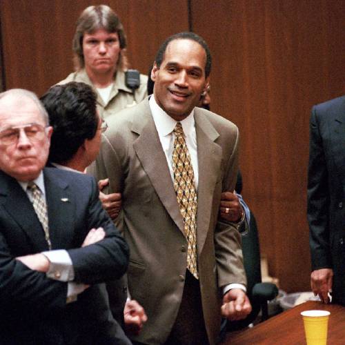 O.J. Simpson center clenches his fists in victory after the jury said he was not guilty in the murders of his ex-wife Nicole Brown Simpson and her friend Ronald Goldman in a Los Angeles courtroom as attor