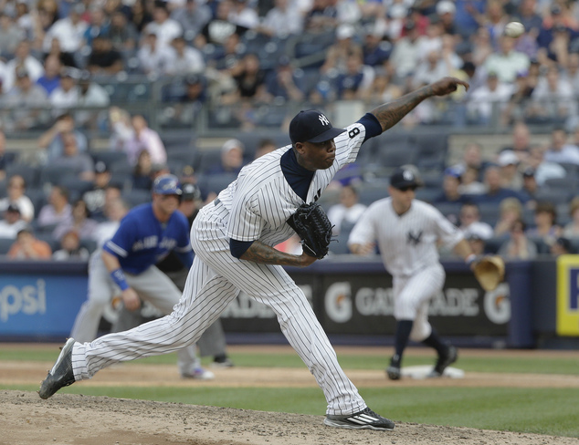 New York Yankees pitcher Aroldis Chapman delivers against the Toronto Blue Jays during the ninth inning of a baseball game Thursday