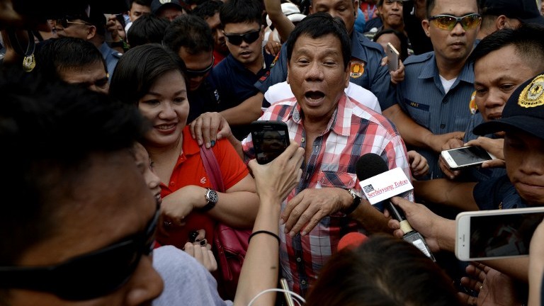 Presidential frontrunner and Davao City Mayor Rodrigo Duterte leaves the voting precint after casting his vote at Daniel Aguinaldo National High School in Davao City on the southern island of Mindanao