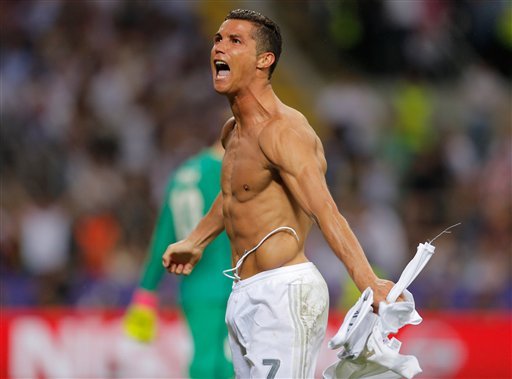 Real Madrid's Cristiano Ronaldo celebrates after scoring the winning penalty shootout during the Champions League final soccer match between Real Madrid and Atletico Madrid at the San Siro stadium in Milan Italy Saturday