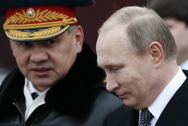 Russian President Vladimir Putin and Defence Minister Sergei Shoigu attend a wreath laying ceremony to mark the Defender of the Fatherland Day at the Tomb of the Unknown Soldier by the Kremlin wall in central Moscow Russia