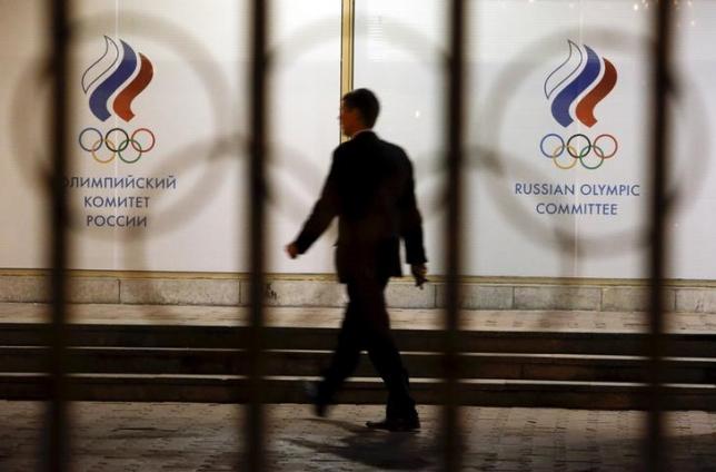 A man walks in front of the Russian Olympic Committee headquarters building which also houses the management of Russian Athletics Federation in Moscow Russia