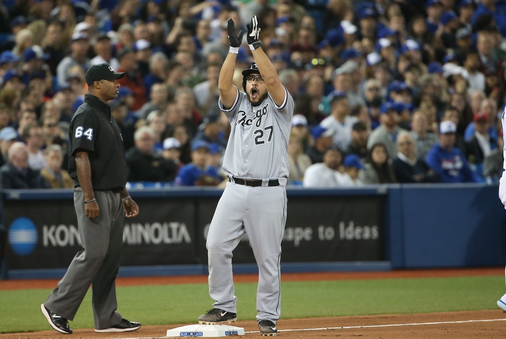 Dioner Navarro celebrates after hitting a two-run triple in the seventh inning during MLB game action against the Toronto Blue Jays