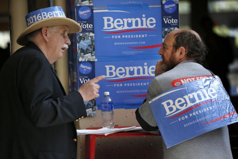 State delegates Chris Neagle of Cumberland left and Seth Berner of Portland discuss political strategy at the state Democratic convention on Friday