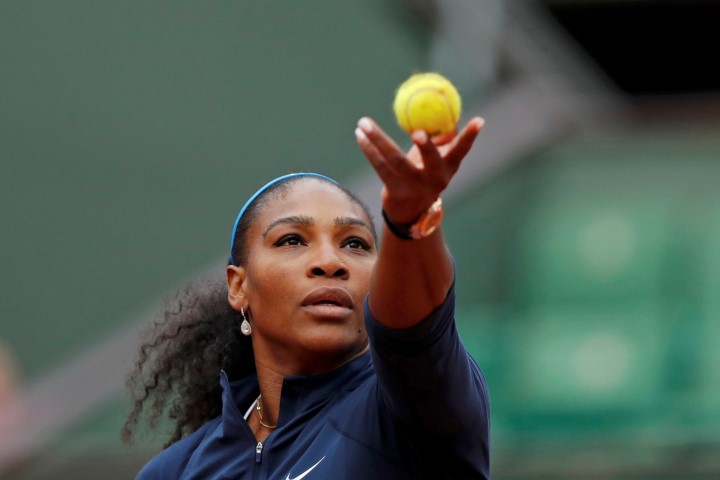 Serena Williams prepares to serve against Magdalena Rybarikova