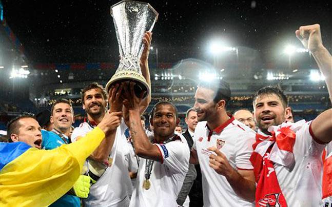 Sevilla players celebrate with the trophy after beating Liverpool in the Europa League final