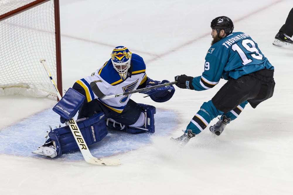 St. Louis Blues goalie Brian Elliott makes a save on San Jose Sharks center Joe Thornton during the first period of the Western Conference Finals- Game 6 between the San Jose Sharks and St. Louis Blues at SAP Center in San Jose CA