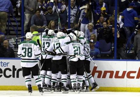 Teammates congratulate Dallas Stars&apos Cody Eakin on his game-winning goal during the overtime of Game 4 of the NHL hockey Stanley Cup Western Conference semifinals against the St. Louis Blues Thursday