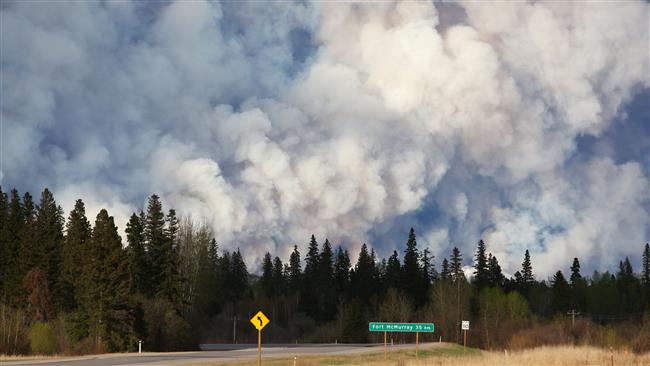 Smoke billows in the sky near Fort McMurray Alberta Canda