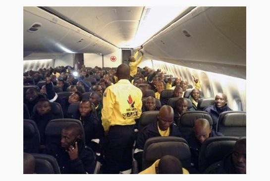 South African firefighters are seen on a an Air Canada plane in Johannesburg South Africa destined for Edmonton on Sunday