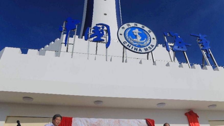 Xinhua News Agency guests attend the completion ceremony for the construction of a lighthouse on Zhubi Reef of Nansha Islands known as the Spratly Islands in the South China Sea