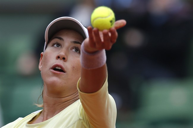 Spain's Garbine Muguruza serves the ball to Russia's Svetlana Kuznetsova during their fourth round match of the French Open tennis tournament at the Roland Garros stadium Sunday