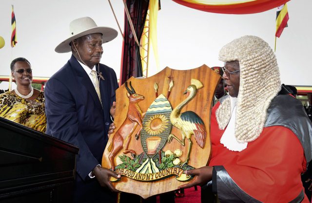 Uganda's long-time president Yoweri Museveni 71 receives a shield as a symbol of power from Chief Justice Bart Katureebe right as his wife Janet Museveni left looks on during an inauguration ceremony in the capital Kampala on Thursday. AP