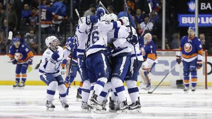 The Tampa Bay Lightning celebrate the game winning goal by Jason Garrison