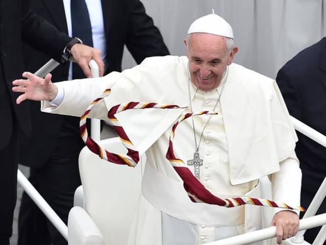 Catholic scouts throw their scarfs to Pope Francis as he greets the crowd after a mass for the Youth day of the Jubilee Year