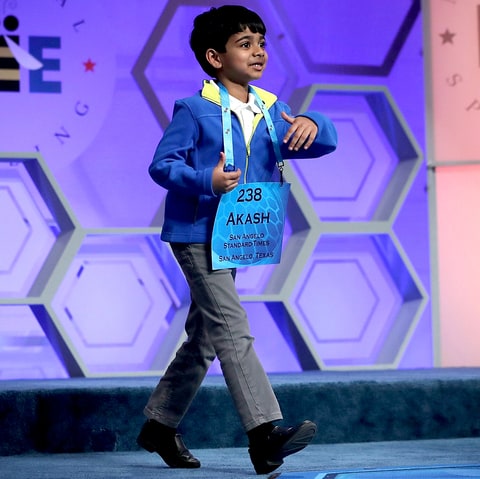 Six-year-old Akash Vukoti of San Angelo Texas approaches the microphone as he participates in round three of the 2016 Scripps National Spelling Bee