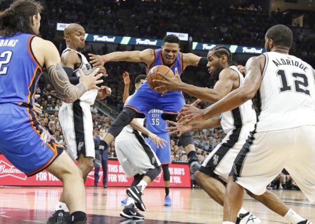 Kawhi Leonard #2 of the San Antonio Spurs strips Russell Westbrook #0 of the Oklahoma City Thunder of the ball in game Five of the Western Conference Semifinals during the 2016 NBA Playoffs at AT&T Center