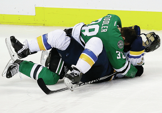 The Stars’ Vernon Fiddler and Blues defenseman Kevin Shattenkirk fight in the third period Saturday’s game in Dallas