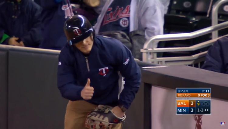 The Twins ball boy signals everything is A-OK after snaring a line drive that was heading for a pair of kids