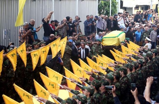 The coffin of Mustafa Badreddine is being carried through the Hezbollah controlled Dahiyeh district of Beirut