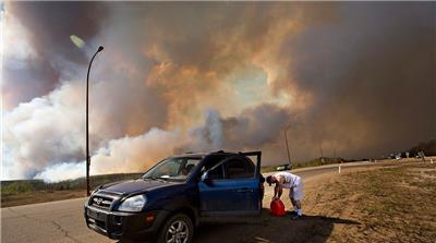 The wildfires have cut Canada's vast oil sands output in half