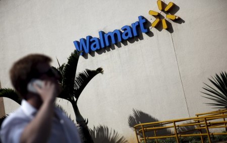 A man talks on his mobile phone in front of a Wal Mart store in Sao Paulo Brazil