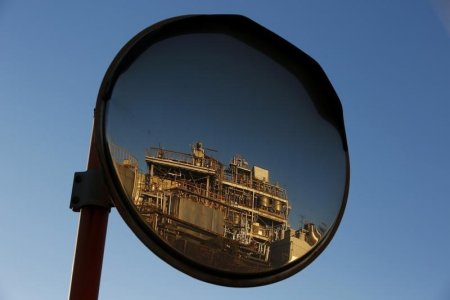 A petro-industrial factory is reflected in a traffic mirror in Kawasaki near Tokyo