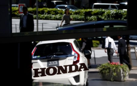 Honda reports quarterly loss on strong yen, air-bag recall