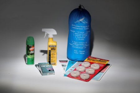 An anti Zika virus kit including a bug net mosquito repellent condoms literature and anti mosquito dunks