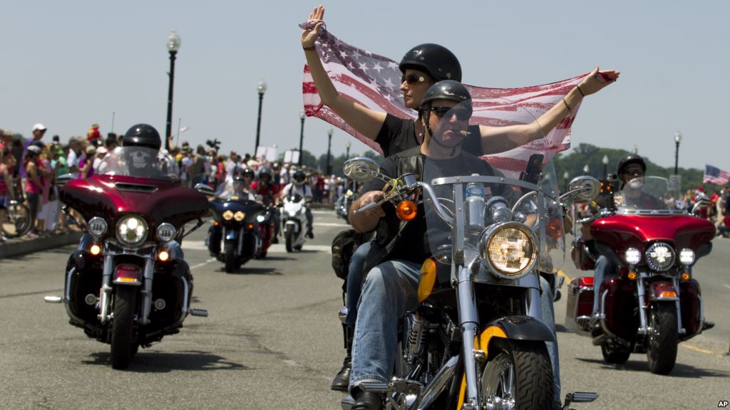 FILE- Participants in the Rolling Thunder annual motorcycle rally ride past Arlington memorial bridge during the parade ahead of Memorial Day in Washington Sunday