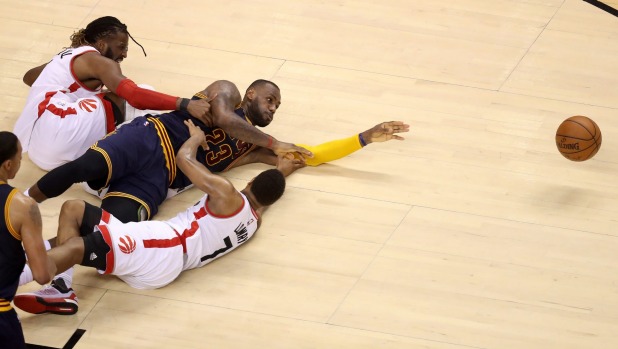 FLOORBALL Cleveland Cavaliers star Le Bron James battles for possession with Toronto Raptors players De Marre